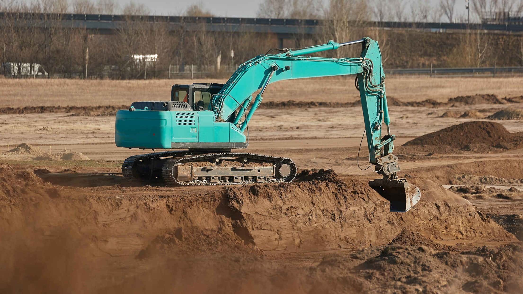 The best soil for foundations image featuring an excavator at a construction site